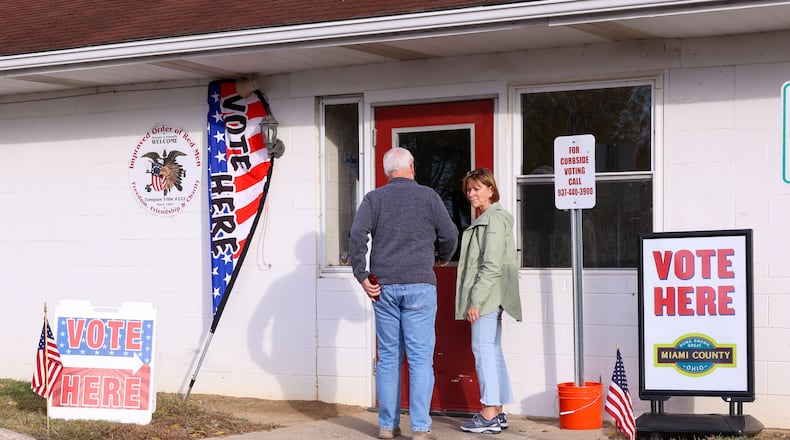 Voters headed to the polls across the area on Tuesday, Nov. 4, including at Redman's Picnic Grounds in Troy. A cat, who poll workers said lives nearby, was greeting voters who were entering the precinct. Poll workers said the cat has done the same on previous election days. BRYANT BILLING/STAFF