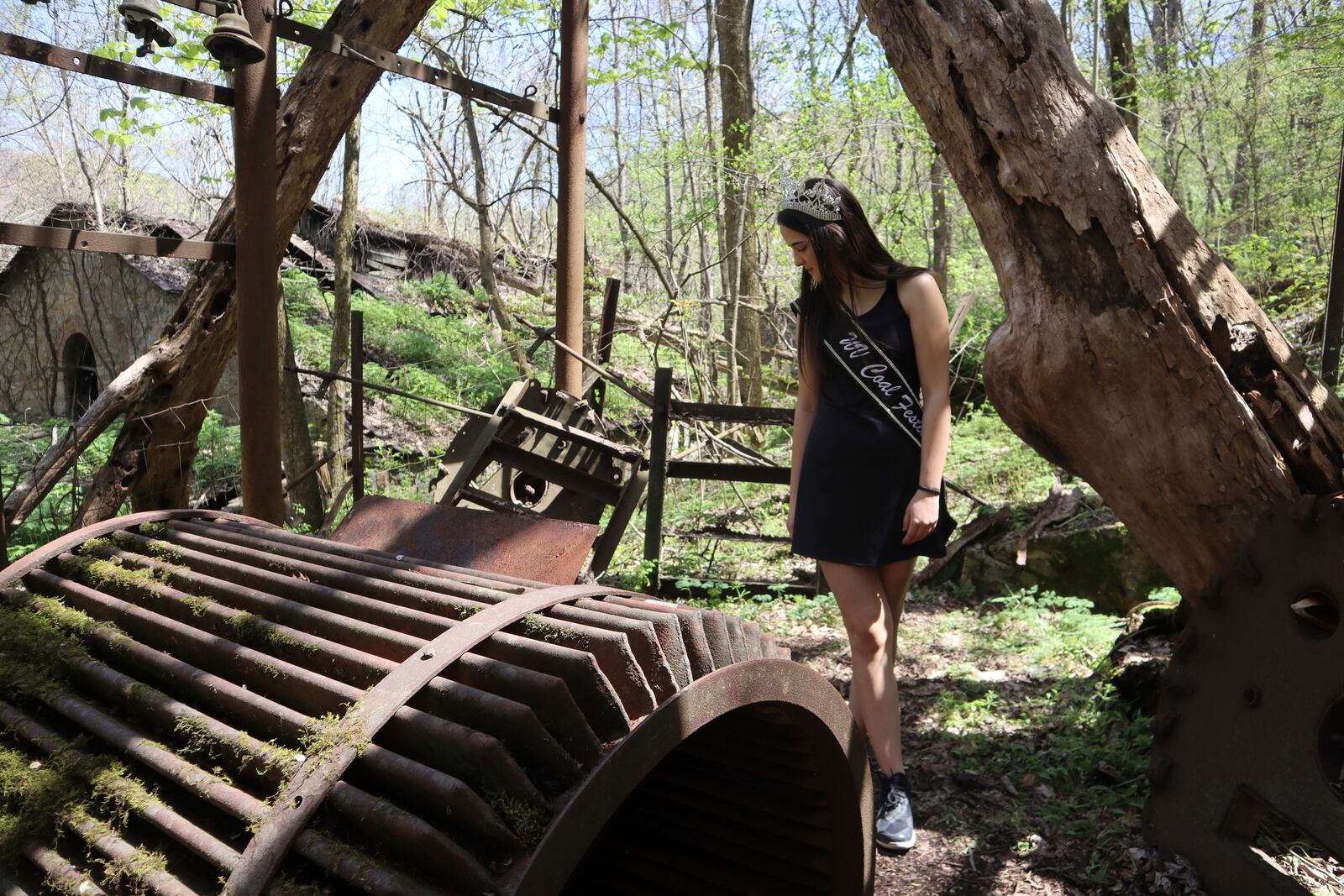 West Virginia Coal Festival teen beauty pageant winner Ava Johnson, 16, explores the ruins of the former Kay Moor coal town and camp in the New River Gorge National Park and Preserve near Fayetteville, W.Va., Thursday, April 17, 2025, (AP Photo/Leah Willingham)