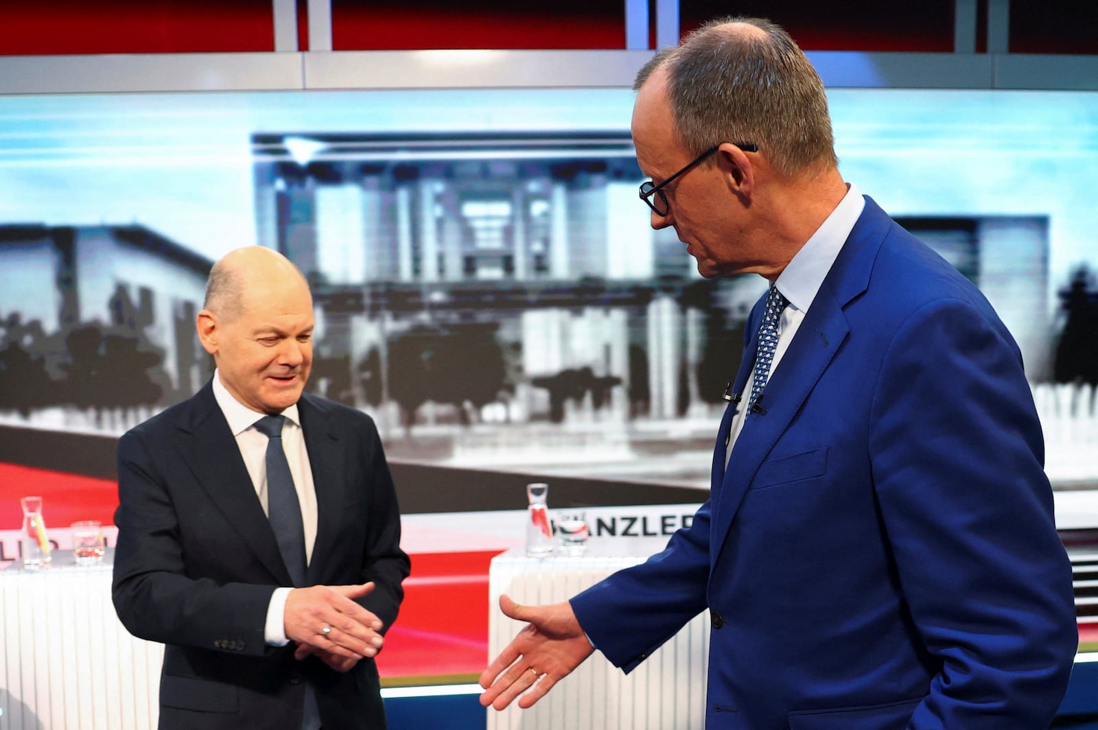 FILE -Olaf Scholz, German Chancellor of the Social Democratic Party (SPD), left, and Friedrich Merz, right, leader of the Christian Democratic Union (CDU), are pictured in tv studio ahead of a debate in Berlin, Germany, Feb. 19, 2025. (Fabrizio Bensch/Pool Photo via AP, File)