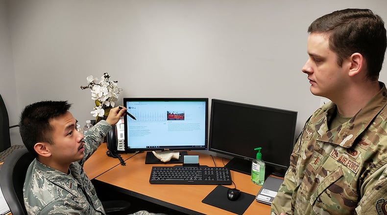 2nd Lt. Wyatt Chen, 88th Communications Squadron cyber intelligence analyst, and 2nd Lt. Kyle McReynolds, officer in charge, 88 CS Cyber Intelligence Analysis Cell, discuss how to avoid social media disinformation on March 31. (U.S. Air Force photo/2nd Lt. Jorge Colon-Soto)