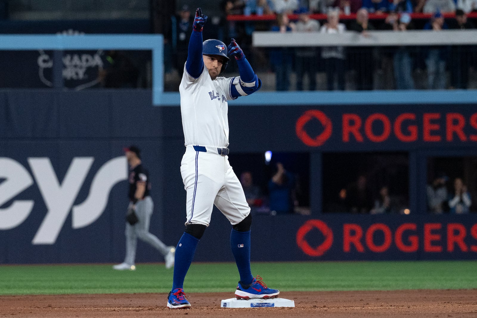 Toronto Blue Jays right fielder George Springer (4) gestures to the dugout after hitting a double against the Cleveland Guardians during the first inning of a baseball game in Toronto, Saturday, May 3, 2025. (Jon Blacker/The Canadian Press via AP)