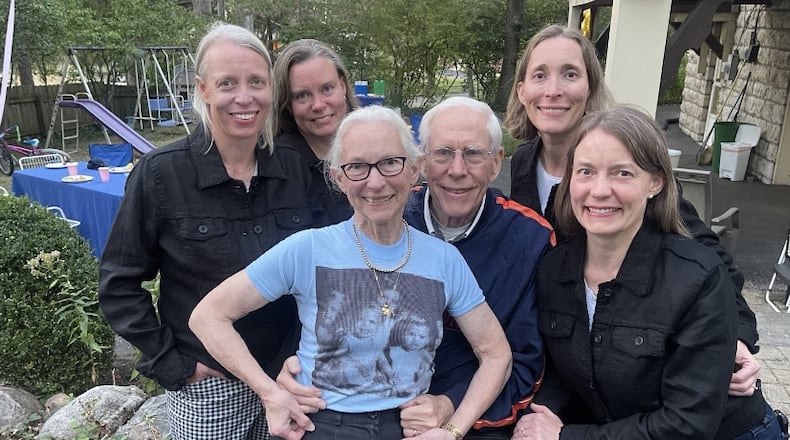 The Dedden quadruplets are seen in birth order from left to right: Katy Deddens Dalrymple, Patty Deddens,  Molly Deddens Blumer. Amy Deddens Carter with Ruth and Bob Deddens in the middle. Ruth is wearing a shirt that has a photo of the siblings when they were younger. Bob had it made at a fair from a photo he had in his wallet when the quads were toddlers, and Ruth still has the short. CHARLIE BLUMER/CONTRIBUTED