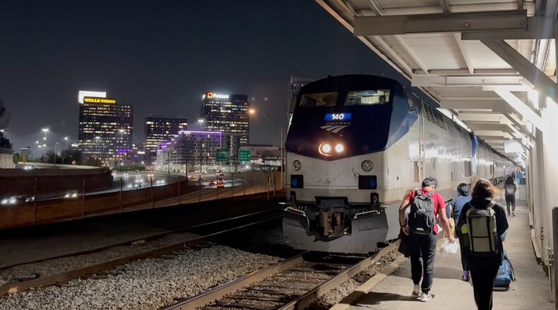 This image made from an Associated Press video shows passengers boarding the Amtrak Crescent headed towards New York on Thursday, March 26, 2026, in Atlanta. (AP Photo/Bill Barrow)