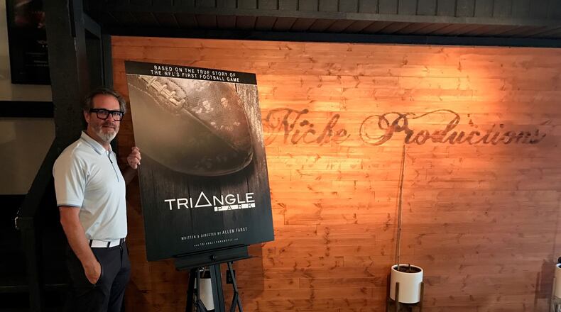 Local filmmaker Allen Farst at his Niche Production headquarters in Centerville with a poster for his upcoming documentary, “Triangle Park,”  and the NFL’s first-ever game, played right here in Dayton by the Dayton Triangles and the Columbus Panhandles at Triangle Park in 1920. Tom Archdeacon/STAFF