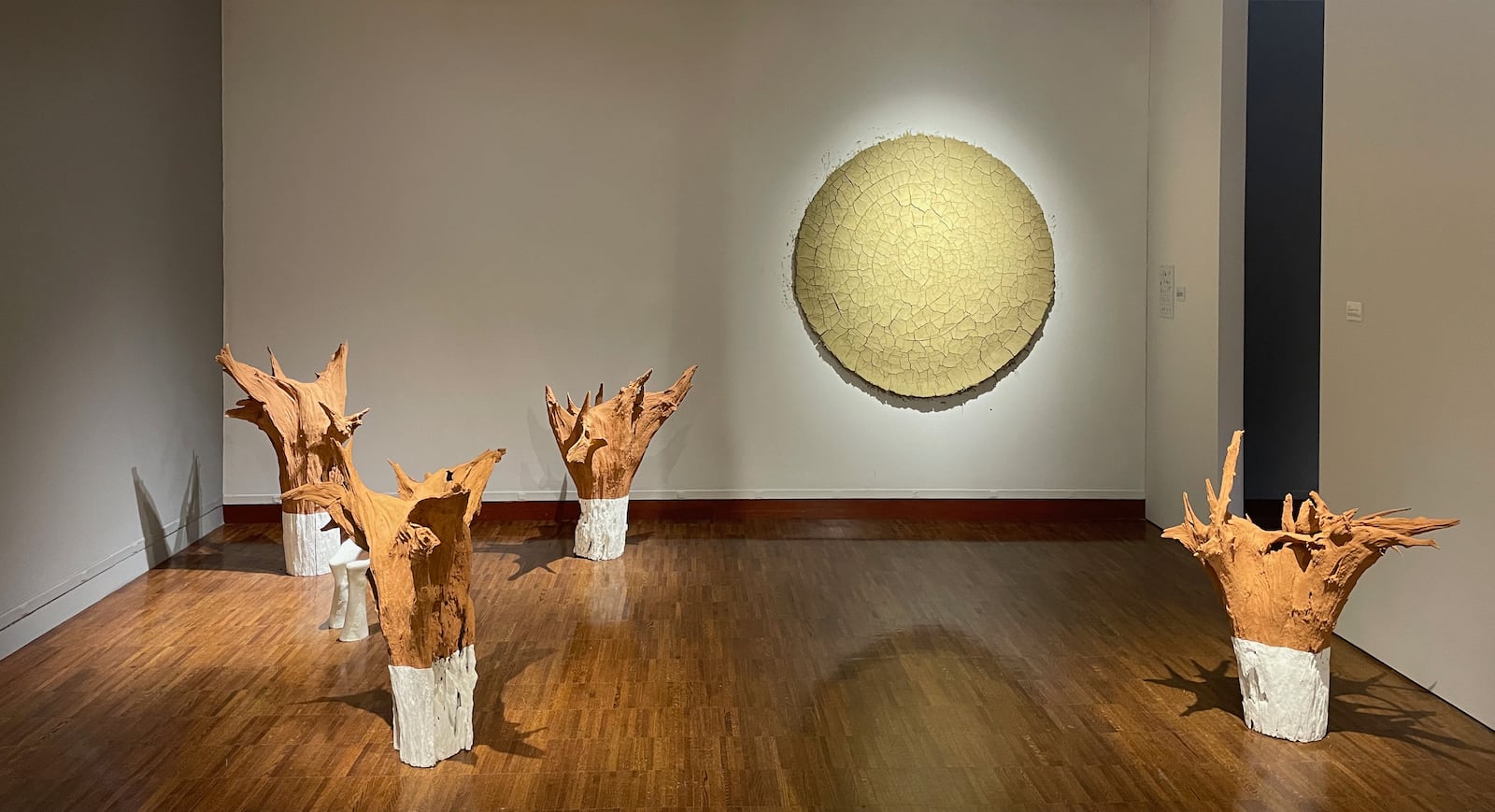 Installation view of 'Clive Moloney: Between Trees' featuring 'Rewild' and 'Unearthed', both 2025. Carved into the wild clay of 'Rewild' is a spiral, a form evocative of time and mortality with cultural echoes ranging from Hitchcock’s “Vertigo” to Robert Smithson’s “Spiral Jetty”. CONTRIBUTED