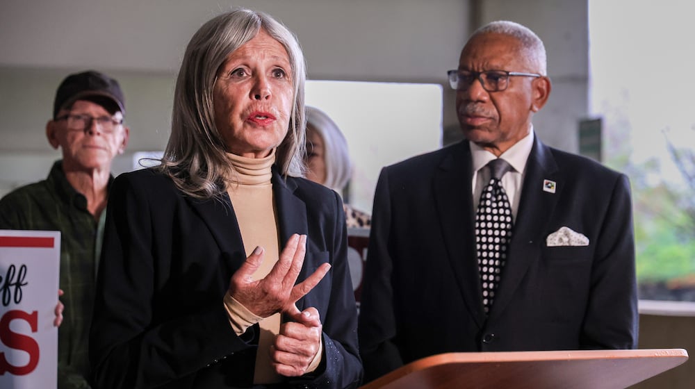 A Dayton Daily News file photo of former Dayton City Commission candidate Karen Wick talking while mayor Jeffrey Mims Jr. listens during an early voting rally on Oct. 7, 2025 outside Montgomery County Board of Elections in downtown Dayton. Wick died Saturday, Dec. 6, 2025. BRYANT BILLING / STAFF