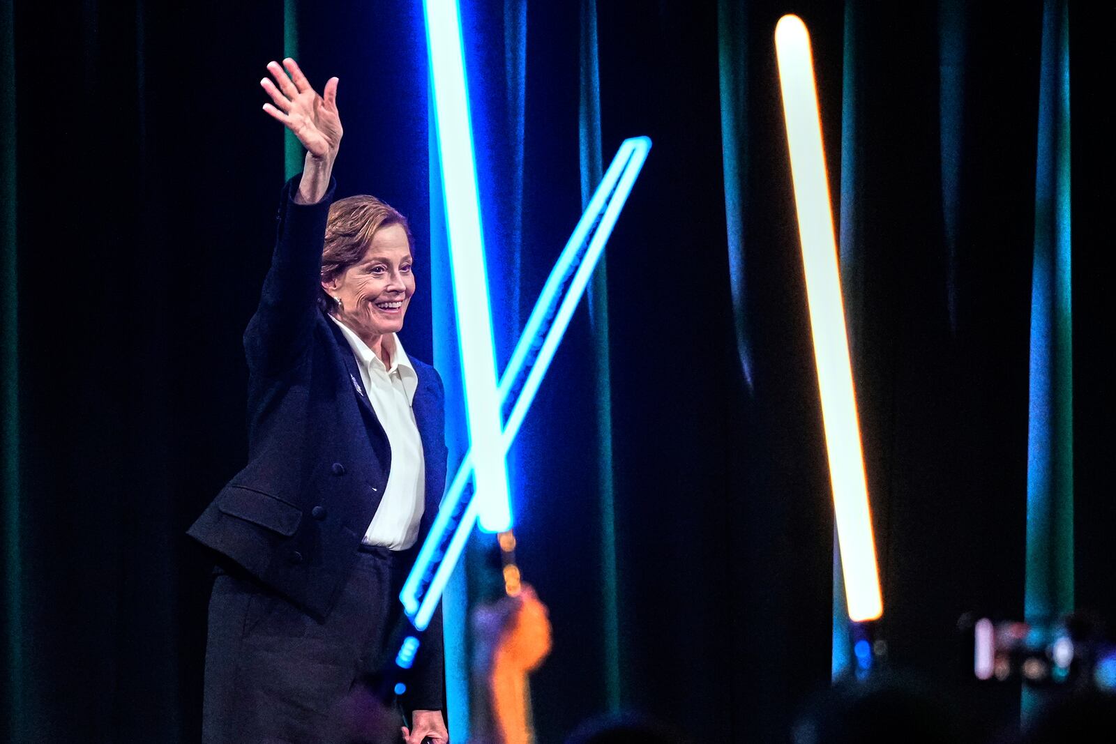 Actor Sigourney Weaver waves to audience members during a fan convention called the Star Wars Celebration Japan in Chiba, near Tokyo, Friday, April 18, 2025. (AP Photo/Hiro Komae)
