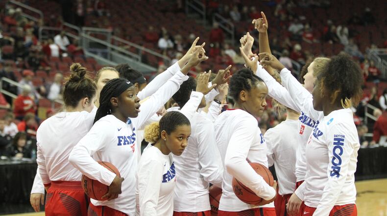 Dayton huddles before a NCAA tournament game against Marquette on Friday, March 16, 2018, at the KFC Yum! Center in Louisville, Ky. David Jablonski/Staff