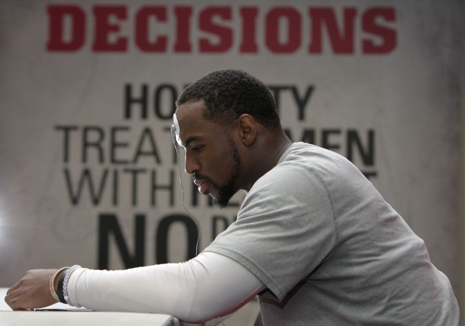 In this Sept. 16, 2015, photo, Ohio State safety Tyvis Powell looks at his phone during his daily biometrics monitoring before practice in Columbus, Ohio. Ohio State uses the device to track overall physiological readiness of players and how they hold up to the wear and tear of football. (AP Photo/Jay LaPrete)