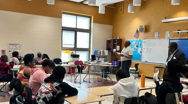 Donerik Black, Learn to Earn's Manager of Place-Based Strategies, talks with students at a Dayton Public school about the student vision initiative. Courtesy of Learn to Earn