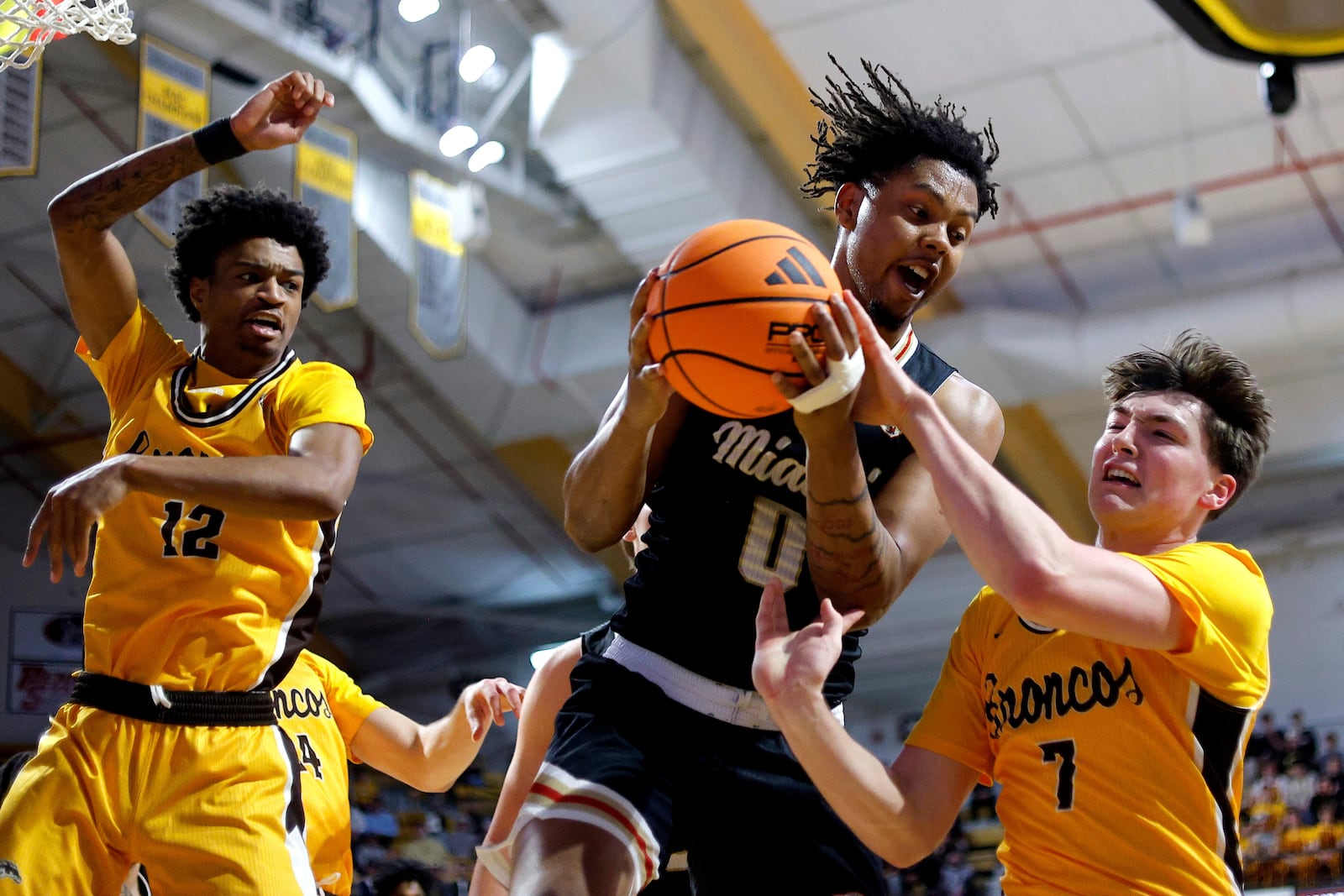Miami (Ohio) forward Eian Elmer (0) pulls down a rebound against Western Michigan guards Jayden Brewer (12) and Carson Vis (7) during the first half of an NCAA college basketball game, Friday, Feb. 27, 2026, in Kalamazoo, Mich. (AP Photo/Al Goldis)
