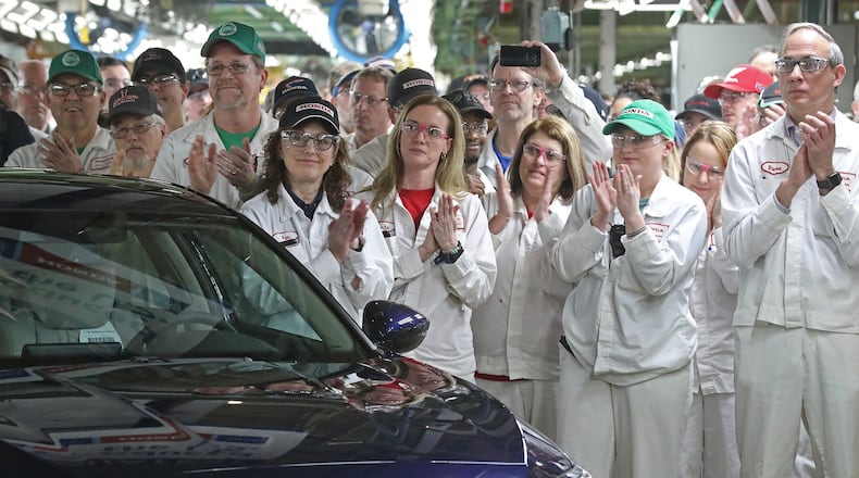 Workers work on a manufacturing line at Honda plant in Anna, Ohio. BILL LACKEY