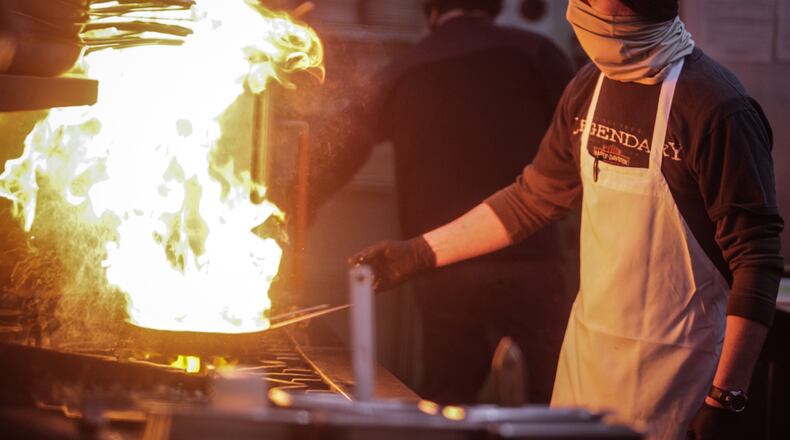 Wellington Grille cook, John Eichelberger fires up tuna on the grill at the restaurant Tuesday Feb. 9, 2021. Wellington Grille cooks and servers are hoping for an uptick of customers this Valentine's Day weekend. JIM NOELKER/STAFF