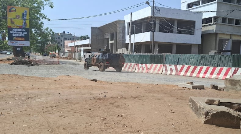 Soldiers ride in a military vehicle along a street amid an attempted coup in Cotonou Benin, Sunday Dec. 7, 2025. (AP Photo)