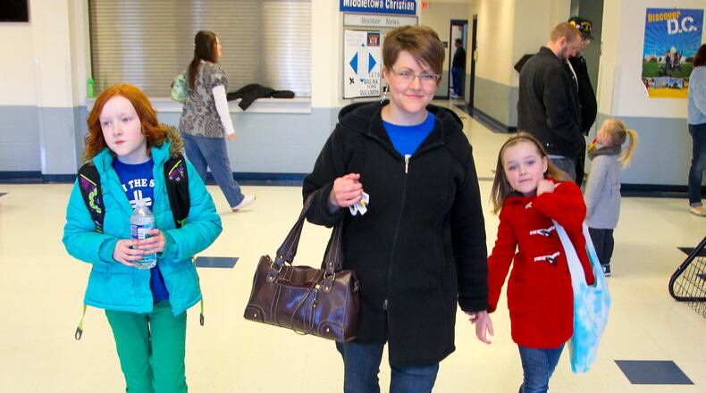 Charlotte Lovelace picks up her kids, Carrie, 10, and Molly, 8, at Middletown Christian School, Friday, March 8, 2013. Ohio governor John Kasich has proposed an expansion of Ohio's EdChoice school voucher program. The Lovelace's use publicly funded vouchers to send their girls to Middletown Christian School, which is a private school. GREG LYNCH / STAFF