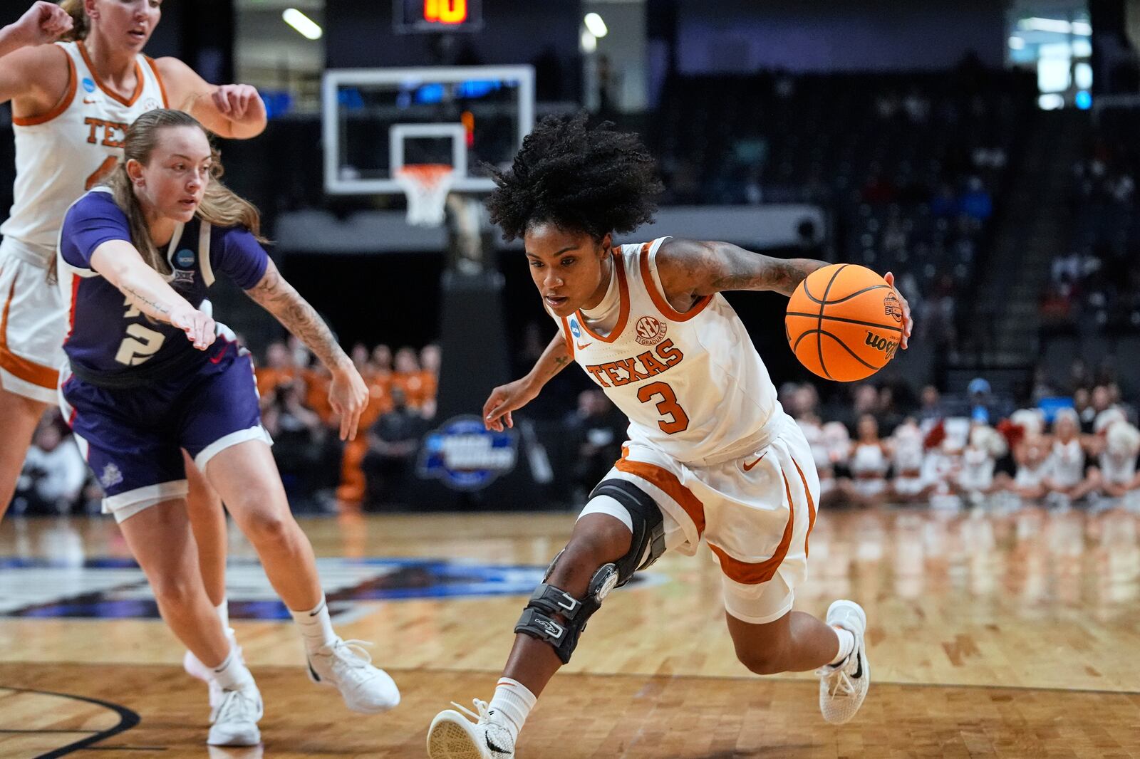 Texas guard Rori Harmon (3) drives to the basket during the first half against TCU in the Elite Eight of the NCAA college basketball tournament, Monday, March 31, 2025. in Birmingham, Ala. (AP Photo/Gerald Herbert)