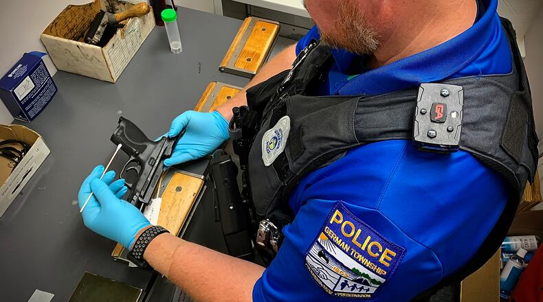 German Twp. Police Officer Steven Marsden swabs a firearm Thursday, July 21, 2022 at the German Twp. Police Department. German Twp. will have to send DNA evidence to the Bureau of Criminal Investigation lab in London after the Miami Valley Regional Crime Lab discontinued DNA testing. MARSHALL GORBY\STAFF