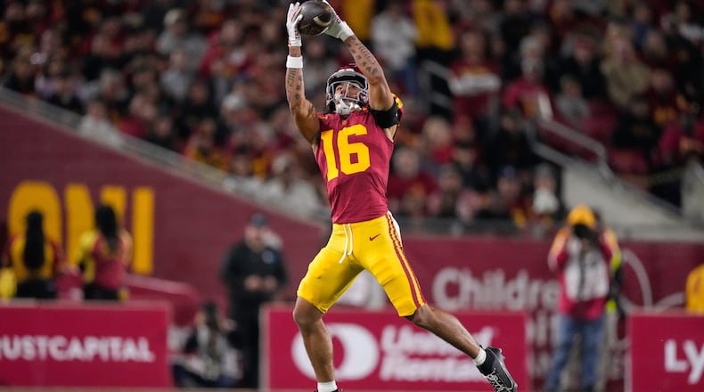 Southern California wide receiver Tanook Hines catches a pass thrown by punter Sam Johnson during the first half of an NCAA college football game against Northwestern, Friday, Nov. 7, 2025, in Los Angeles. (AP Photo/Mark J. Terrill)