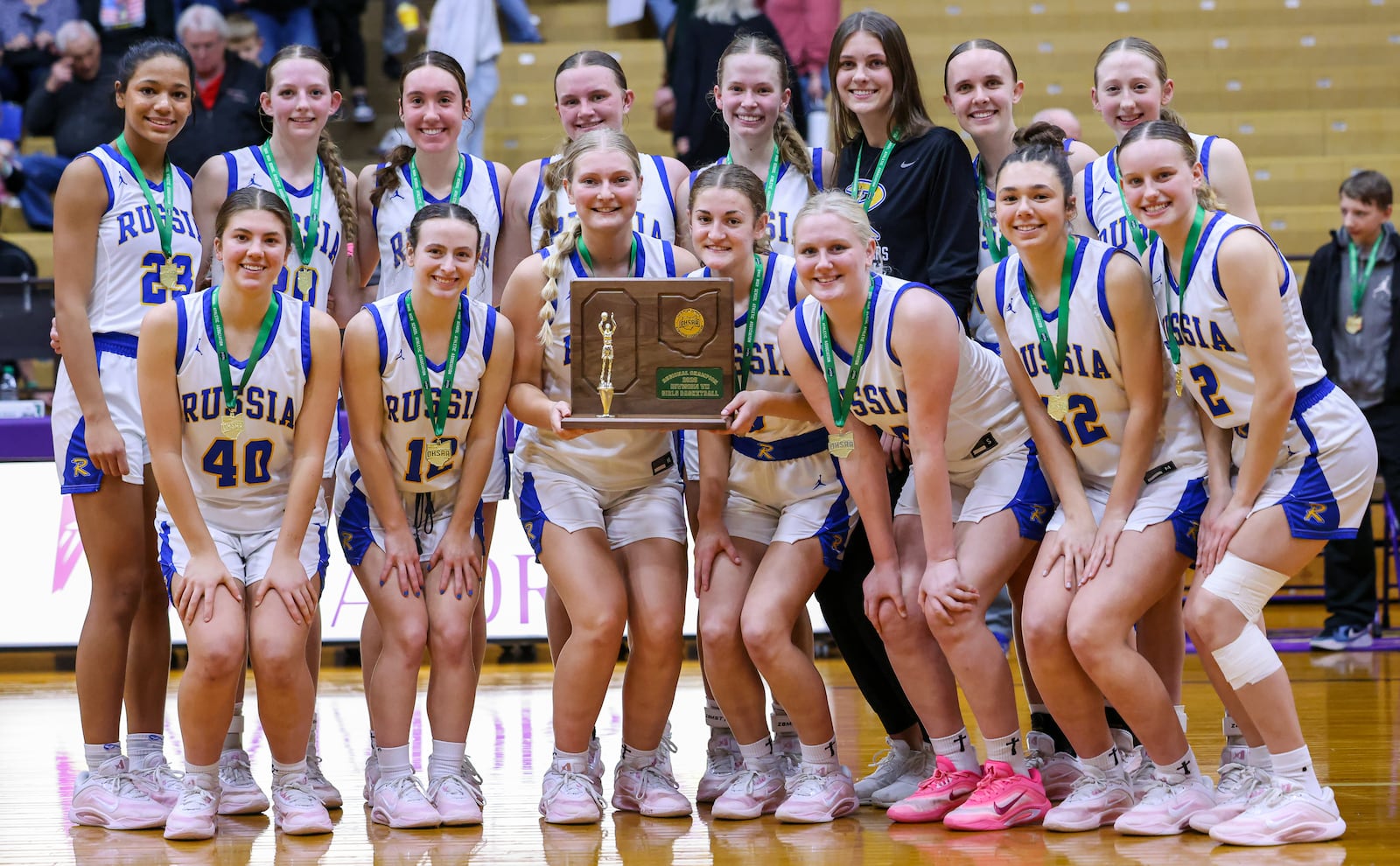 Russia players pose with a Division VII regional championship trophy following a 40-32 win over Cedarville on Saturday, March 7 at Vandalia-Butler's Student Activity Center. BRYANT BILLING / STAFF