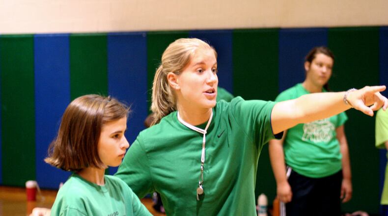 Former CJ star Megan Duffy gives some pointers to Sarah Reymann of Oakwood during Chaminade Julienne’s girls basketball camp in 2009. FILE PHOTO