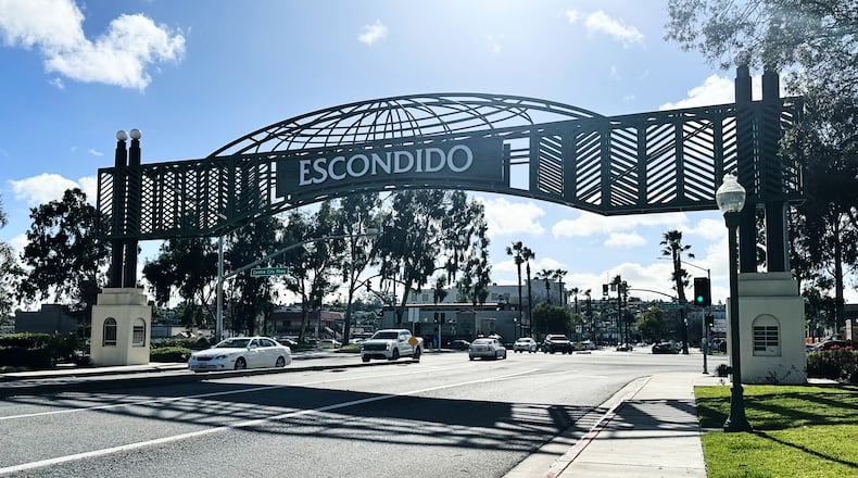 Motorists drive under a city sign on Wednesday, Feb. 18, 2026 in Escondido, Calif. (AP Photo/Amy Taxin)