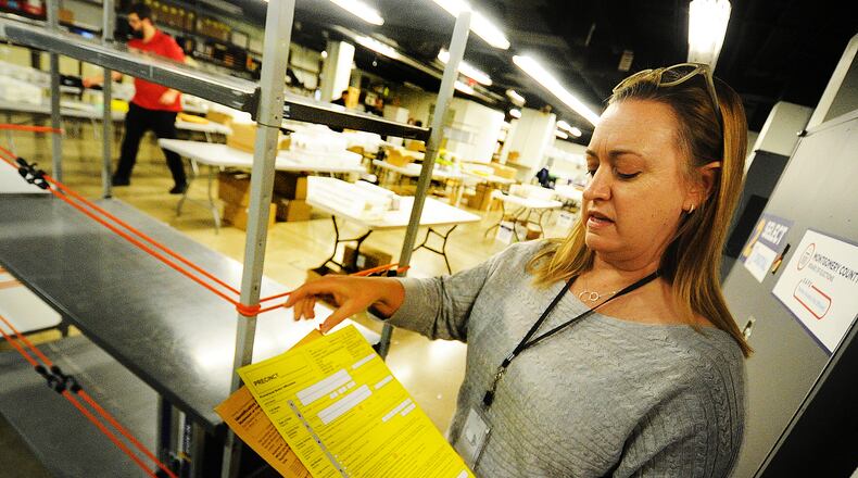 Montgomery County Board of Elections Deputy Director Sarah Greathouse shows an example of a provisional ballot envelope at the board of elections Wednesday, November 9, 2022. Thousands of provisional and absentee ballots may still be counted. MARSHALL GORBY/ STAFF