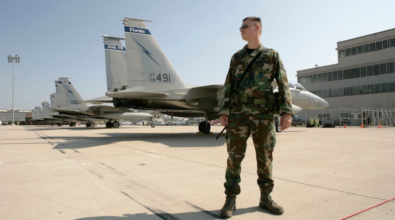 SSgt. Glenn Fritch with the 125th Security Forces Squadron from the Florida Air National Guard watches over the 13 F-15 Eagles flown to Wright-Patterson Air Force Base until Tropical Storm Hanna passes by Florida. Base Spokesman Derek Kaufman exects more airplanes including F-15E Strike Eagles form Seymour Johnson AFB in North Carolina and C-17 Globemasters from Charleston AFB in South Carolina on Friday. Staff photo by Ty Greenlees.