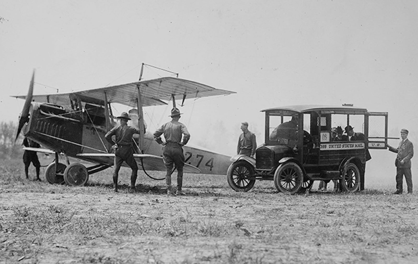 In this photo provided by the National Archives and Records Administration, mail is loaded onto a Curtiss JN-4H "Jenny" biplane, May 15, 1918, at Bustleton Field near Philadelphia, while U.S. Army personnel look on. (National Archives and Records Administration via AP)