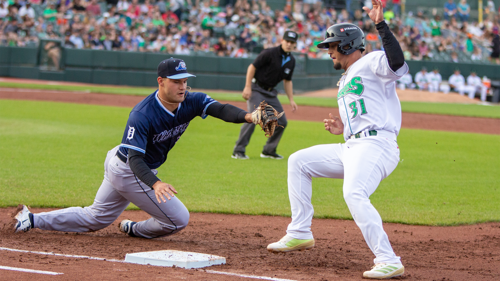 Dayton's Ricky Cabrera makes it safely back to first ahead of the tag by West Michigan's Josue Briceno on a pickoff throw from the catcher Wednesday night at Day Air Ballpark. Cabrera later scored on a single by Johnny Ascanio. Jeff Gilbert/CONTRIBUTED