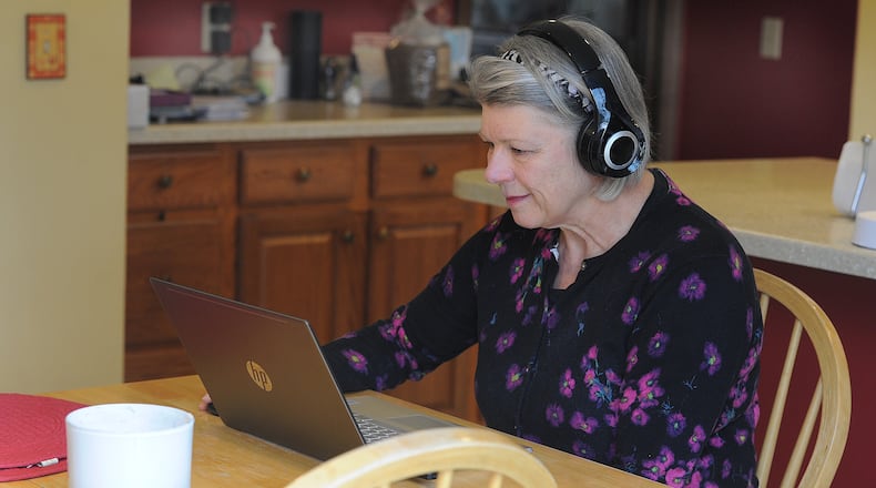 Laurel Kerr, 59, of Centerville, working from her home is one of about 50 volunteers who facilitate mediation sessions in Dayton. MARSHALL GORBY\STAFF