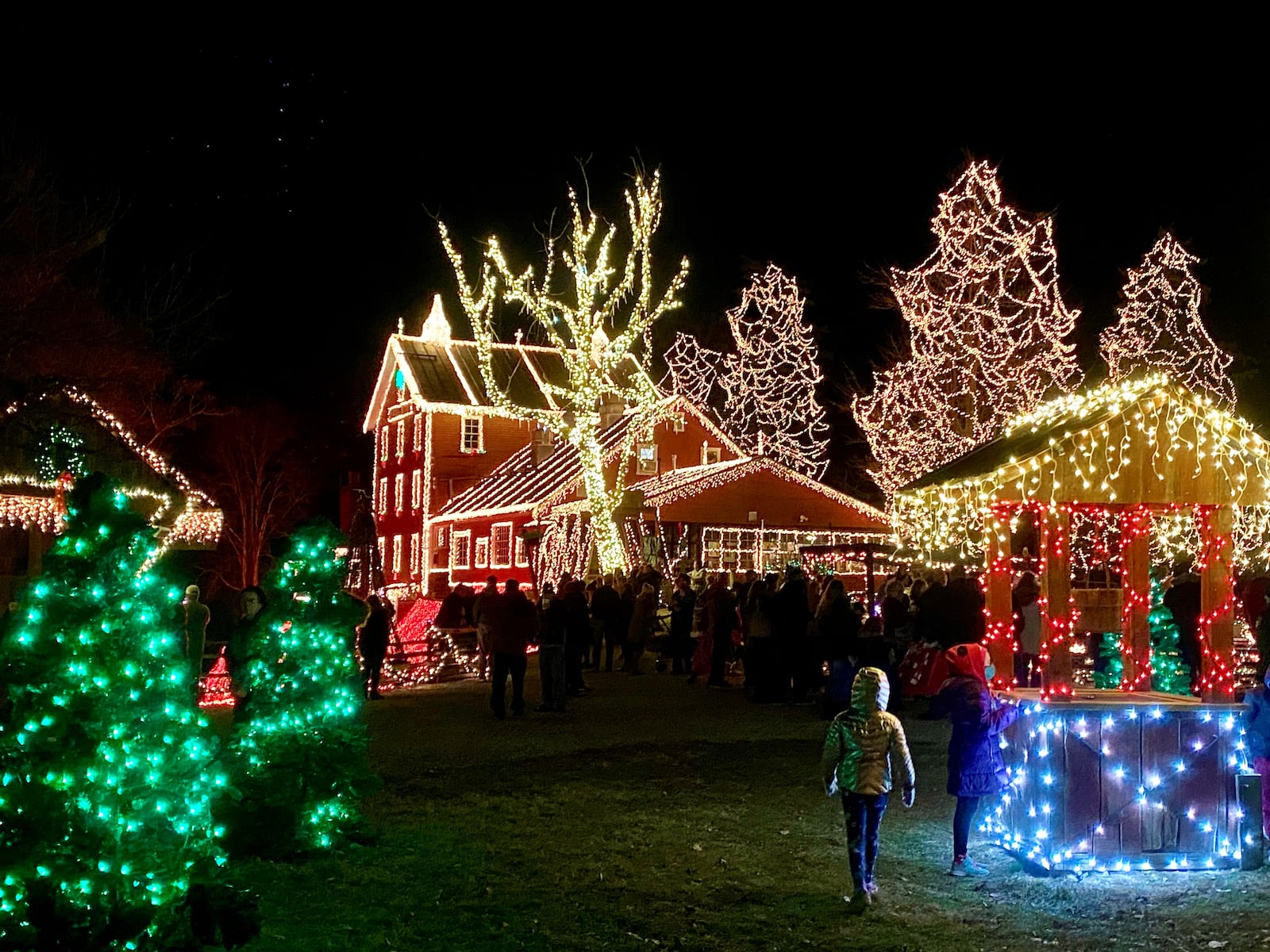Visitors take in the Legendary Lights at the historic Clifton Mill, just outside Yellow Springs, Friday, Dec. 2, 2022. The mill, built in 1802 and still a working, has become a Miami Valley institution around the holidays. GREG LYNCH / STAFF