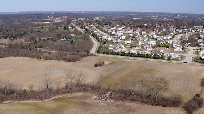 This view looking north in Miamisburg shows land south of Benner Road and the Terrington Place neighborhood. Plans for Deer Valley development on this land include 197 homes, six of them estate homes with four of those set to develop in the northwest corner of the property. Mound Road, center, leads to the former Mound Labs facility at the upper left of the photo. STAFF FILE PHOTO