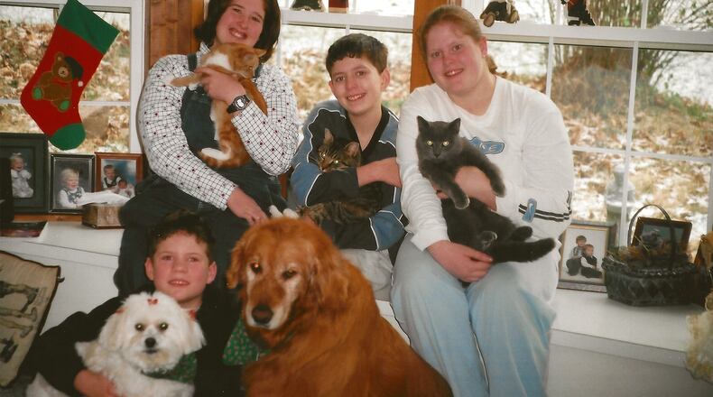 Peggy and Jim Hanna's adopted children Joe on the floor, and (L-R) Lois, Jon and Crystal in 2000. Today, Peggy lives with Crystal and Joe lives next door.