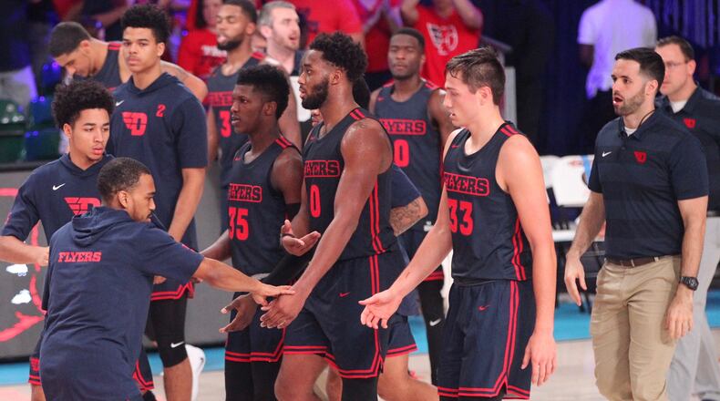 Dayton’s Camron Greer slaps hands with players as they leave the court at home of a game against Oklahoma in the Battle 4 Atlantis on Friday, Nov. 23, 2018, on Paradise Island, Bahamas. David Jablonski/Staff