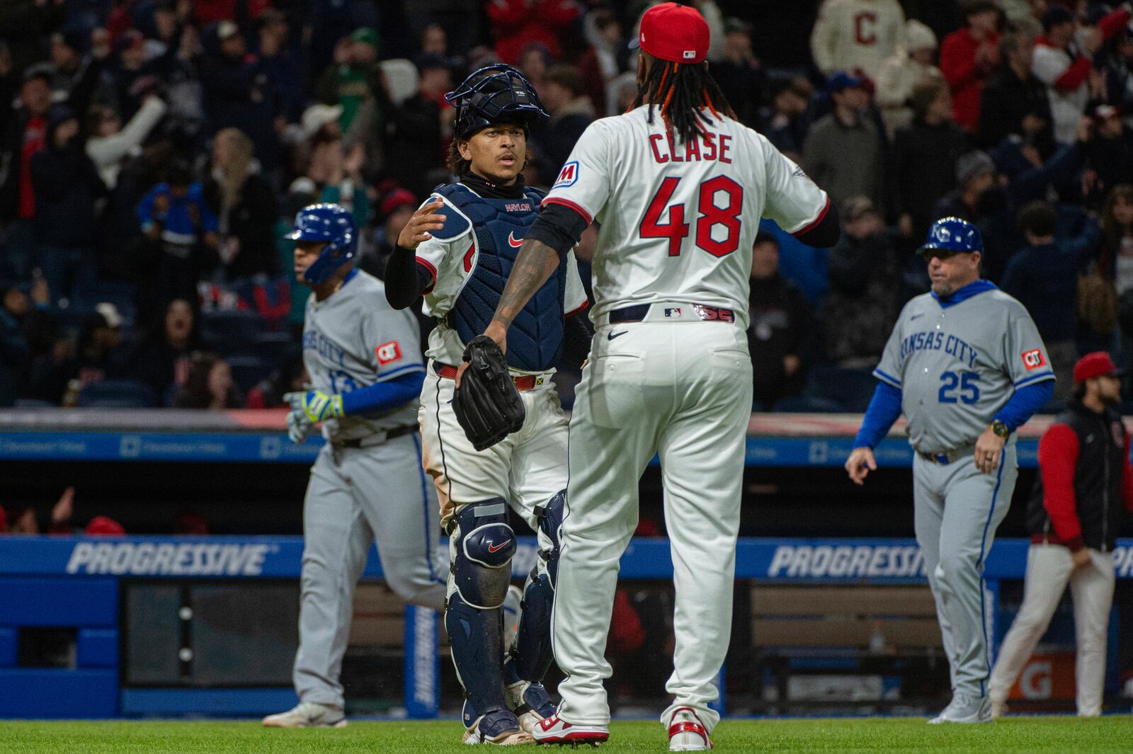 Cleveland Guardians' Bo Naylor, left, congratulates Cleveland Guardians relief pitcher Emmanuel Clase (48) at the end of a baseball game against the Kansas City Royals in Cleveland, Saturday, April 12, 2025. (AP Photo/Phil Long)