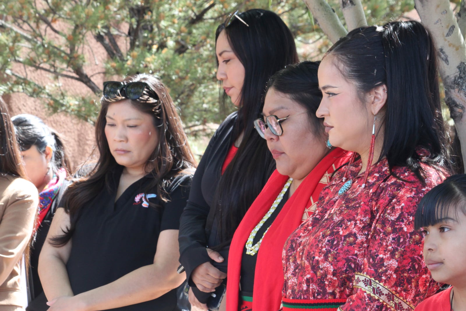 A group of women listen to a prayer before participating in a walk marking Missing and Murdered Indigenous Persons Awareness Day at the Indian Pueblo Cultural Center in Albuquerque, New Mexico, on Monday, May 5, 2025. (AP Photo/Susan Montoya Bryan)