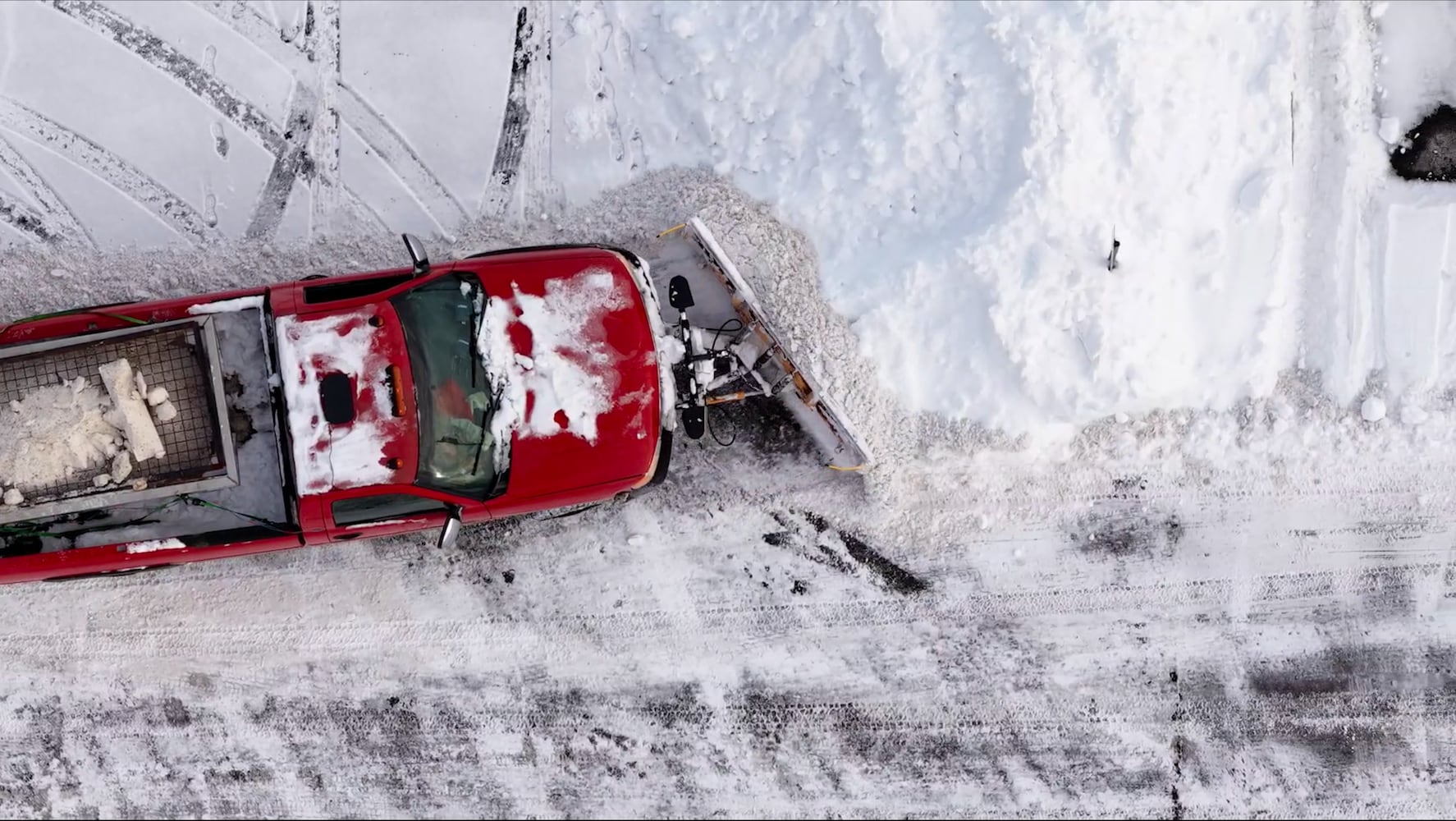 Snowplow clears a parking lot after weekend snowstorm in southwest Ohio