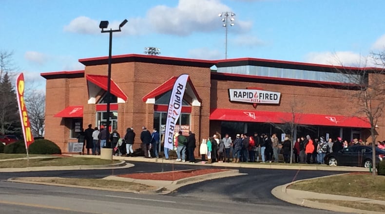 Hungry customers line up outside Rapid Fired Pizza in Kettering on Friday, Dec. 30, 2016, for the restaurant's free pizza promotion. The promotion will run through 8 p.m. or as supplies last. JEREMY KELLEY/STAFF