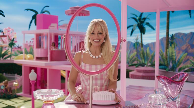 Margot Robbie as Barbie on the very pink set of “Barbie.” (Warner Bros. Pictures/TNS)