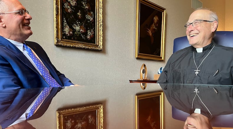 University of Dayton President Eric Spina, left, and the Rev. James Fitz, UD's rector and vice president for mission, share a laugh in Spina's office on June 26, 2025. THOMAS GNAU/STAFF