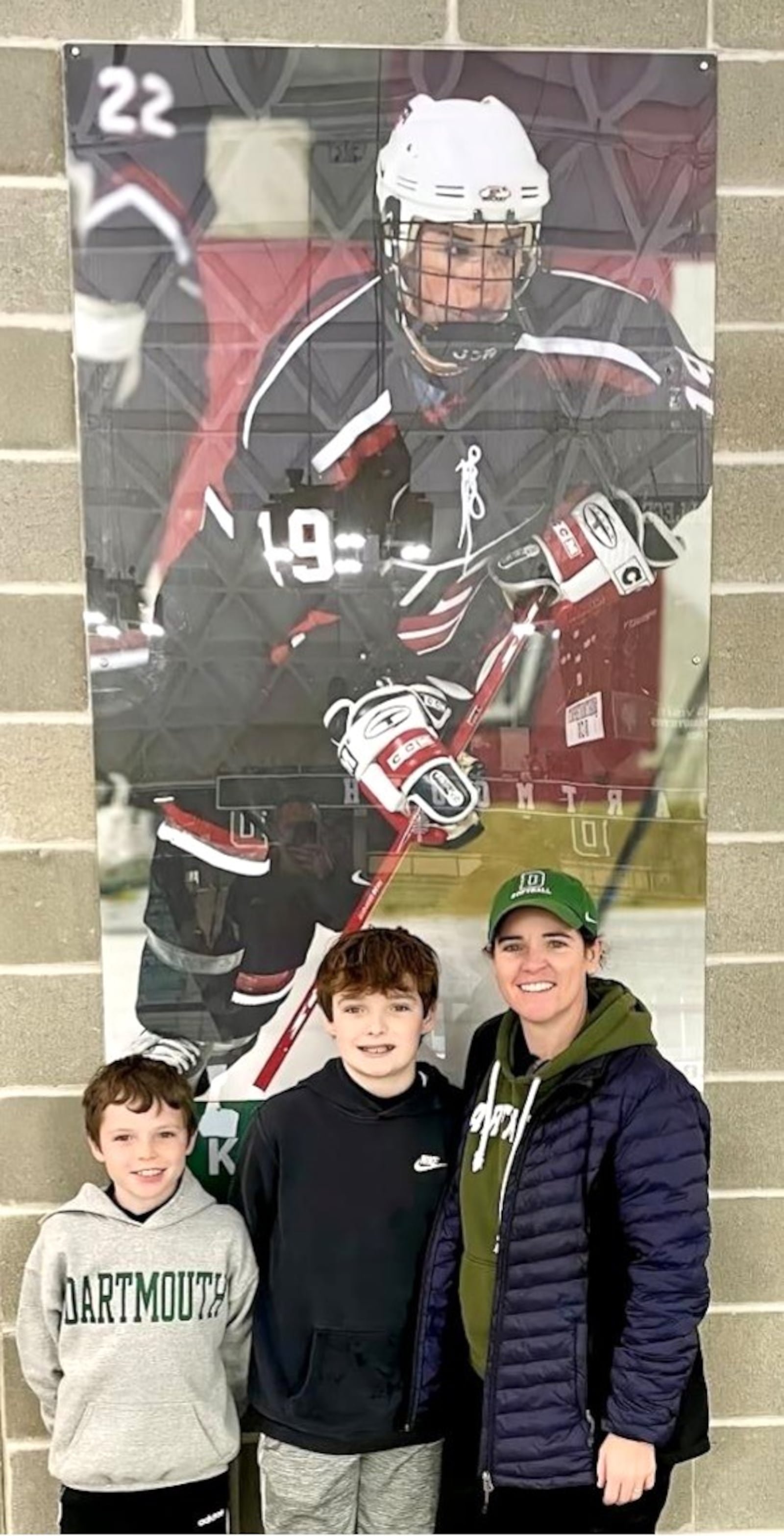Kettler (left), Logan and Kristin King Wright pose in front of a poster of her from her hockey glory days. CONTRIBUTED PHOTO