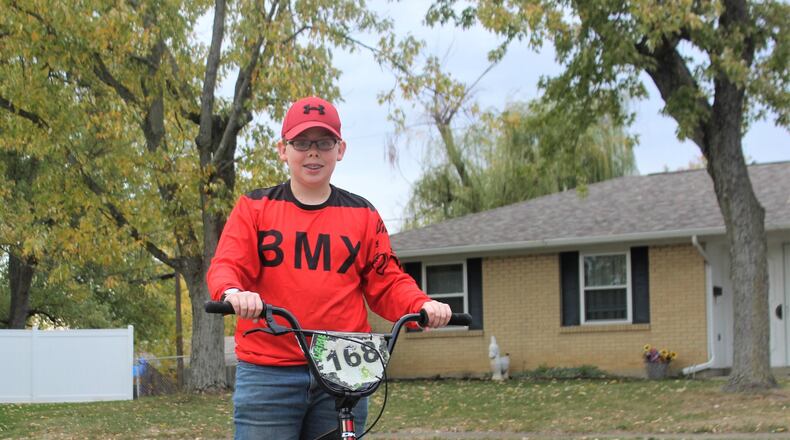 Nicholas Lamb rides his BMX bike in his Huber Heights neighborhood. Lamb wants a skate park to be built in Huber so that he and other kids can safely do the sport. STAFF/BONNIE MEIBERS