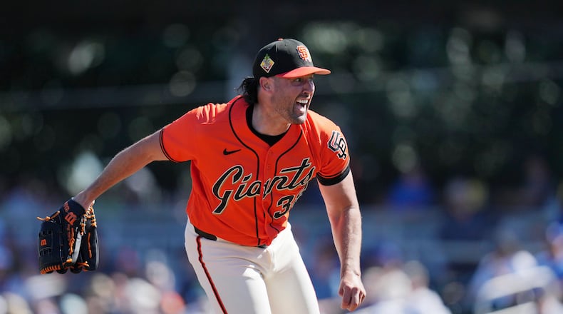 San Francisco Giants starting pitcher Robbie Ray follows through with his pitch delivery during the first inning of a spring training baseball game against the Los Angeles Dodgers Friday, Feb. 27, 2026, in Scottsdale, Ariz. (AP Photo/Ross D. Franklin)