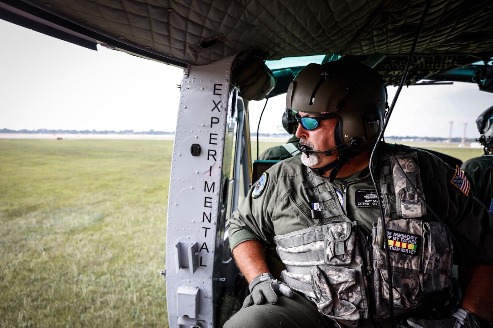 The crew of a Huey helicopter gets ready to take off at the Dayton Air Show on Saturday, June 22, 2024, with Dayton Daily News photographer Jim Noelker aboard.