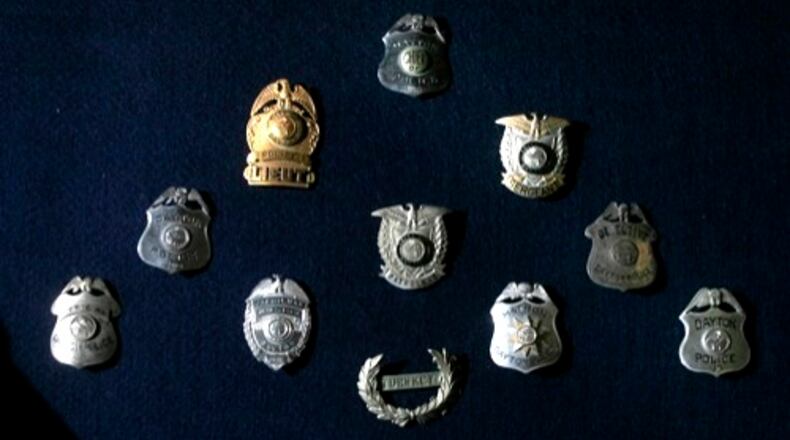 A collection of Dayton Police Department shields on display at the Dayton Police Academy. STAFF