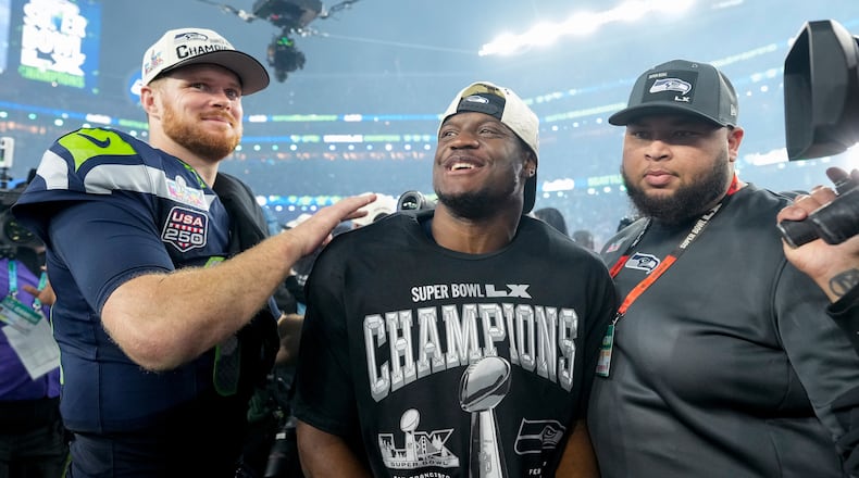 Seattle Seahawks quarterback Sam Darnold, left, and teammate running back Kenneth Walker III celebrate after defeating the New England Patriots in the NFL Super Bowl 60 football game, Sunday, Feb. 8, 2026, in Santa Clara, Calif. (AP Photo/Brynn Anderson)