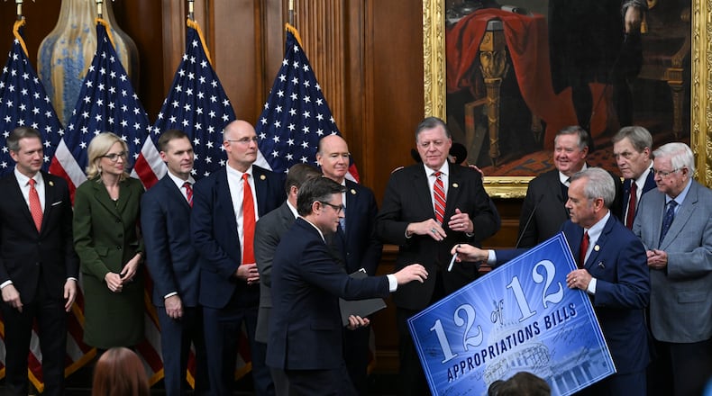 House Speaker Mike Johnson (R-La.) goes to sign a poster at a news conference about the passage of appropriations bills at the Capitol in Washington, on Thursday, Jan. 22, 2026. The House on Thursday passed legislation to fund a broad swath of the government including the Department of Homeland Security, narrowly mustering the votes amid a Democratic revolt over spending for Immigration and Customs Enforcement. (Kenny Holston/The New York Times)