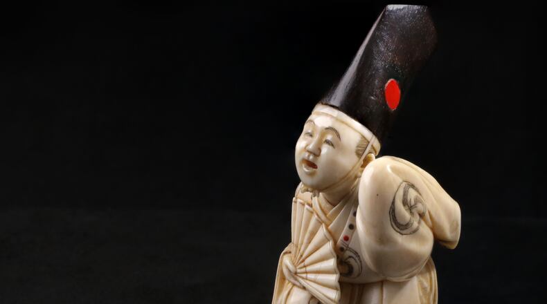 Netsuke in the Shape of a Sambaso Dancer, late 19th–early 20th century, ivory, wood, inlay. CONTRIBUTED