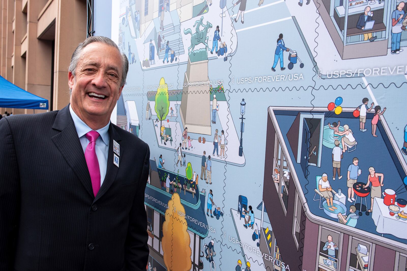 Postmaster General David Steiner stands next to a just unveiled stamp which marks the 250th anniversary of the postal service, Wednesday, July 23, 2025, in Washington. (AP Photo/Cliff Owen)