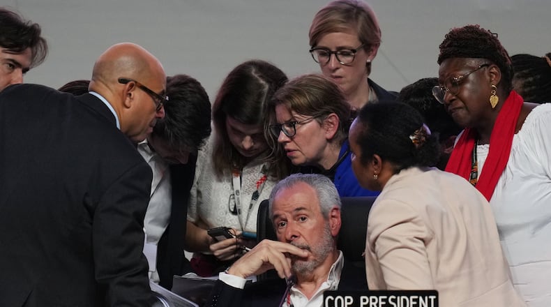 André Corrêa do Lago, COP30 president, sits as Simon Stiell, United Nations climate chief, left, speaks with other U.N. officials during a plenary session at the COP30 U.N. Climate Summit, Saturday, Nov. 22, 2025, in Belem, Brazil. (AP Photo/Andre Penner)